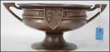 An unusual heavy bronze twin handled bowl raised o