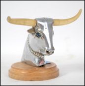 A 20th century chrome car mascot in the form of a Bulls head with light up horns.