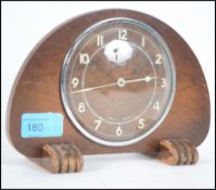 A vintage 20th century Art Deco style Metemec Dereham wooden cased mantle clock raised on wooden