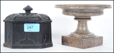 A polished stone urn with inclusive limpet fossils