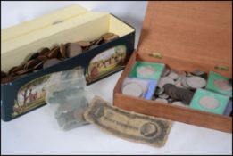 A tin full of 20th Century pennies and half pennies with some others weighing in at well over 5kg.