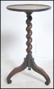 A small 19th century tripod wine table being raise