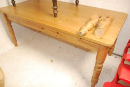 A large country pine antique style dining table raised on turned legs with fitted frieze having