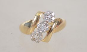 A 10ct gold and diamond ring with three daisy set diamond clusters. Size O. Weight 2g. Marked 10K