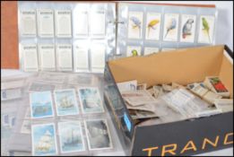 An album of cigarette cards to include Wix's, Players, Wills etc. Together with a box of loose cards