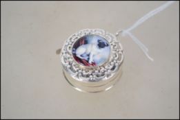 A silver cased tape measure mounted with a plaque