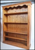 A contemporary 20th century pine open bookcase of