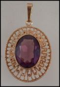 A vintage hallmarked 9ct gold and amethyst pendant. Hallmarked import London. Weight 9.5g.