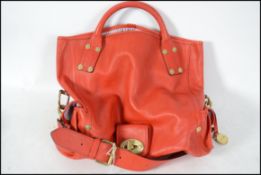 An original Mulberry red leather tote bag. This handbag has a fully adjustable shoulder strap with