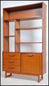 A 1970's teak wood room divider bookcase having sectional upright body being raised on turned and