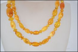A vintage 20th century butterscotch amber ladies bead necklace having shaped amber beads complete