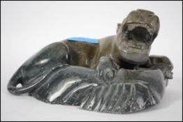 An Oriental green soapstone carving of a roaring t