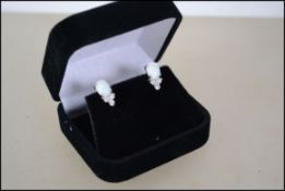 A pair of CZ and opal stud earrings