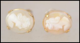 A pair of 9ct gold mounted screw back cameo earrings having rope twist borders