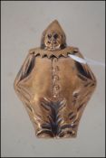 A brass vesta case in the form of a clown.