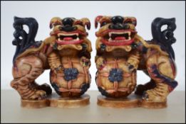 A pair of 20th century heavy marble matching temple dogs / dogs of fu