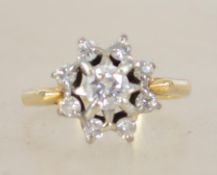 An 18ct gold and diamond ring having starburst mou