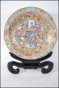A large Chinese famille rose charger  - plate with foliate and vine decoration having cartouche