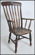 A Victorian beech and elm windsor dining chair having turned legs united by stretchers with saddle