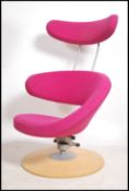 A retro Stokke Peel designer swivel armchair raised on terraced base having shaped purple velour