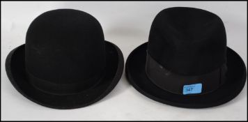 A pair of vintage 20th century bowler hats one wit