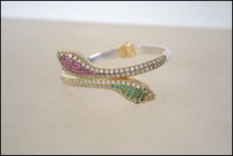 A silver and semi precious stone snake bandgle