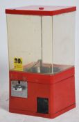 A 20th century retro gumball machine having four clear sides with a coin turn operation to the