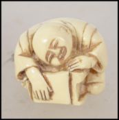 A carved Japanese bone netsuke signed to the base