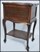 A 1920's oak sewing box being raised on shaped ser