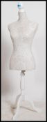 A contemporary dress makers dummy ( possibly Laura