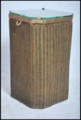 A mid century retro 20th century Lloyd Loom lusty ware laundry bid with glass hinged top over