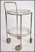 A retro mid century 1950's butlers serving trolley of gilded tubular metal construction having