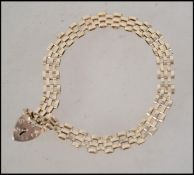 A hallmarked 9ct gold checkered box link bracelet chain having a heart locket clasp. Hallmarks to
