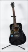 An acoustic six string Spanish style guitar with an ebonised body with applied label to centre for