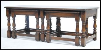 A 20th century  Ercol dark elm nest of long John t