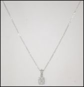 A hallmarked 950 platinum and diamond pendant necklace. A platinum pendant necklace strung with a