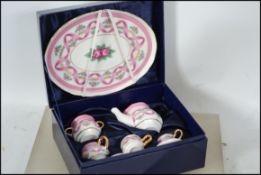 A cased china dolls tea service