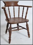 An Edwardian mahogany smokers bow armchair - windsor chair raised on turned legs with spindle