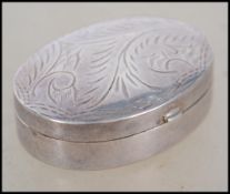 A silver hallmarked pill box of lozenge form being