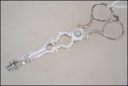 A pair of Georgian silver sugar nips, maker's mark