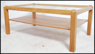 A 1970's teak wood and glass coffee occasional tab