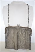 A large silver hallmarked mesh purse. The silver b