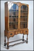 A late 19th century Queen Anne walnut display cabi