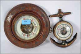 A vintage 1920's mahogany wheel barometer with ceramic dial and open window to movement. Together