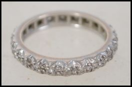 An 18ct white gold and diamond ladies eternity ring, each diamond being illusion set. Total weight