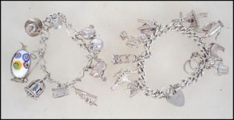 2 silver charm bracelets with many silver charms including some very unusual pieces.