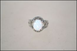 A silver marcasite and large opal dress ring. Weight 8.4g. Size Q.