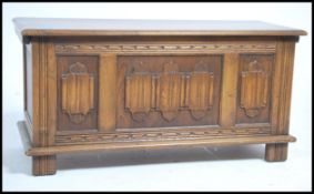 An Old Charm moulded oak hinge top  panelled coffe