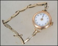 A vintage 20th century ladies 9ct gold ladies wrist watch having an enamel face on a filled gold