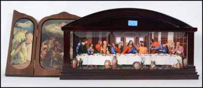 A wooden tryptych opening to reveal ceramic religious panels depicting the birth of christ by